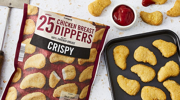 image of a packet of chicken dippers next to a baking tray full of chicken dippers as well as some tubs of ketchup